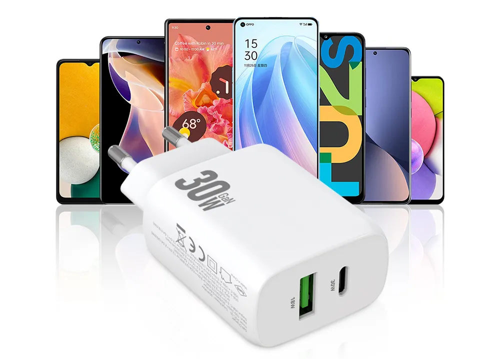 vit mobilladdare, i bakgrunden mobiltelefoner